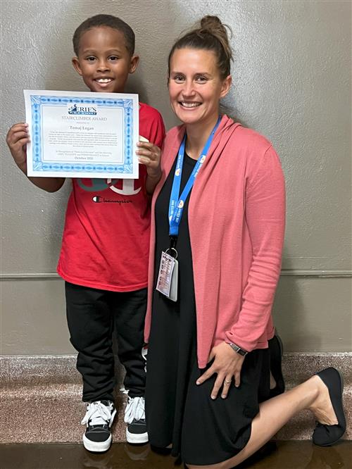 Tomaj Logan, Edisons's Stairclimber for October, poses with his award plaque.